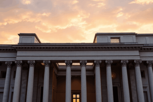 A majestic classical building with Renaissance columns and arches combined with modern minimalist design, set against a serene sunrise sky.